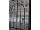 Backyard view through decorative ironwork onto a refreshing swimming pool and patio seating at 9511 Teton Vista Ave, Las Vegas, NV 89117