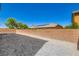 A home's backyard includes a concrete block wall, and landscaping at 9712 Rocket Grove Ct, Las Vegas, NV 89178