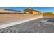 A newly constructed backyard with a retaining wall and some landscaping at 9712 Rocket Grove Ct, Las Vegas, NV 89178