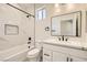 A modern bathroom with marble tile, a soaking tub, and black hardware at 9712 Rocket Grove Ct, Las Vegas, NV 89178