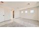 A spacious bedroom with natural light, neutral carpeting, and doorways leading to a closet at 9712 Rocket Grove Ct, Las Vegas, NV 89178
