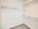 Neat walk-in closet with shelving and plush carpet, providing organized storage solutions at 9712 Rocket Grove Ct, Las Vegas, NV 89178