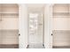 Dual closets with built-in shelving framing a glimpse into a bright, modern bathroom at 9712 Rocket Grove Ct, Las Vegas, NV 89178