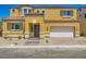 Inviting yellow two-story home featuring a tile roof, charming brick walkway, and attached two-car garage at 9712 Rocket Grove Ct, Las Vegas, NV 89178