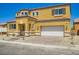 Inviting yellow two-story home featuring a tile roof, charming brick driveway, and attached two-car garage at 9712 Rocket Grove Ct, Las Vegas, NV 89178