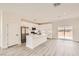 Bright, open kitchen with stainless steel appliances and a large center island at 9712 Rocket Grove Ct, Las Vegas, NV 89178