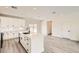 A sleek kitchen boasts white cabinetry, stainless steel appliances, and a stylish island with a sink at 9712 Rocket Grove Ct, Las Vegas, NV 89178
