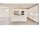 Modern, bright kitchen with white cabinets, stainless steel appliances, and a spacious center island at 9712 Rocket Grove Ct, Las Vegas, NV 89178