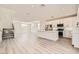Bright, modern kitchen featuring white cabinets, stainless steel appliances, and a large island open to the living area at 9712 Rocket Grove Ct, Las Vegas, NV 89178