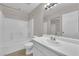 Well-lit bathroom featuring a shower-tub combo and a vanity with sink and large mirror at 9957 Fine Fern St, Las Vegas, NV 89183