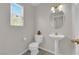 Charming powder room features a pedestal sink, decorative mirror, and natural light at 9957 Fine Fern St, Las Vegas, NV 89183