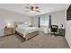 Comfortable bedroom with a ceiling fan, a large bed, and natural light from a window at 9957 Fine Fern St, Las Vegas, NV 89183