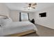 Cozy bedroom showcasing a TV, a large bed, and natural light from a window at 9957 Fine Fern St, Las Vegas, NV 89183