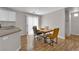 Open dining area with wood floors, modern table set, and seamless flow to the kitchen at 9957 Fine Fern St, Las Vegas, NV 89183
