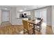 Open dining area with wood floors, modern table set, and seamless flow to the kitchen at 9957 Fine Fern St, Las Vegas, NV 89183