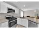 Bright kitchen with stainless steel appliances, light cabinets, and easy access to the dining area at 9957 Fine Fern St, Las Vegas, NV 89183
