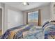 Comfortable main bedroom showcasing a window, ceiling fan, and closet at 9957 Fine Fern St, Las Vegas, NV 89183