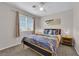 Cozy main bedroom featuring a ceiling fan, large window, and neutral decor at 9957 Fine Fern St, Las Vegas, NV 89183