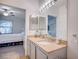 Bathroom featuring granite counters, a vanity with sink, a mirror, and a view of the bedroom and closet at 9975 Peace Way # 1024, Las Vegas, NV 89147
