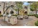 Outdoor kitchen area with barbecue grills and seating surrounded by mature trees at 9975 Peace Way # 1024, Las Vegas, NV 89147