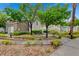 Landscaped community area with walking paths, lush greenery, and mature trees at 9975 Peace Way # 1024, Las Vegas, NV 89147