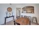 Dining area near arched opening to kitchen with stylish furnishings and decor at 9975 Peace Way # 1024, Las Vegas, NV 89147