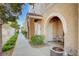 Townhouse entrance featuring an arched entryway and tiled patio at 9975 Peace Way # 1024, Las Vegas, NV 89147
