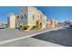 Inviting townhouse complex with attached garages and manicured grounds at 9975 Peace Way # 1024, Las Vegas, NV 89147