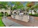 Outdoor grilling area with brick pavers, manicured landscaping and multiple grills at 9975 Peace Way # 1024, Las Vegas, NV 89147