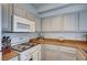 Bright kitchen with stainless-steel appliances, granite counters, and painted cabinets at 9975 Peace Way # 1024, Las Vegas, NV 89147