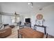 Open concept living room featuring wood-look floors, ceiling fan, and an easel at 9975 Peace Way # 1024, Las Vegas, NV 89147