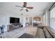 Modern living room with a large TV, a ceiling fan and an adjacent kitchen area at 9975 Peace Way # 1024, Las Vegas, NV 89147