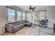 Well-lit living room with an elegant ceiling fan and multiple windows at 9975 Peace Way # 1024, Las Vegas, NV 89147