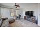 Comfortable living room featuring a large TV and a ceiling fan at 9975 Peace Way # 1024, Las Vegas, NV 89147