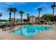 Community pool area featuring palm trees, a covered area, and lounge chairs at 9975 Peace Way # 1024, Las Vegas, NV 89147