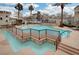 Beautiful pool area with cascading water features, lush landscaping, and surrounding lounge areas at 9975 Peace Way # 1024, Las Vegas, NV 89147
