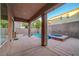 View of the back patio with a covered area, a spa and desert landscaping at 1011 Pecos River Ave, Henderson, NV 89002