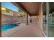 View of the back patio with a covered area, a spa and a grassy area at 1011 Pecos River Ave, Henderson, NV 89002
