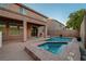 Backyard features a pool and spa, covered patio and desert landscaping at 1011 Pecos River Ave, Henderson, NV 89002