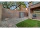Backyard features a grassy area, and desert landscaping at 1011 Pecos River Ave, Henderson, NV 89002