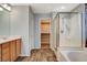 Bathroom featuring a vanity, closet, and a shower/tub combo with glass doors at 1011 Pecos River Ave, Henderson, NV 89002