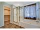 Bathroom featuring a closet, standalone shower with glass doors, and a soaking tub at 1011 Pecos River Ave, Henderson, NV 89002