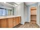 Bathroom featuring dual vanity, closet, and a shower/tub combo with glass doors at 1011 Pecos River Ave, Henderson, NV 89002