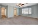 Spacious bedroom features neutral carpet, a ceiling fan, and access to an en-suite bathroom at 1011 Pecos River Ave, Henderson, NV 89002