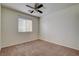 Neutral bedroom features a ceiling fan and window letting in lots of natural light at 1011 Pecos River Ave, Henderson, NV 89002