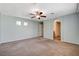 Generous bedroom features carpet, a ceiling fan, and a doorway to another room at 1011 Pecos River Ave, Henderson, NV 89002