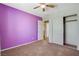 Bedroom features purple accent wall and closet, offering a simple yet inviting space at 1011 Pecos River Ave, Henderson, NV 89002