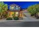 Charming two-story home features a well-maintained lawn, two car garage, and inviting curb appeal at 1011 Pecos River Ave, Henderson, NV 89002