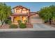 Charming two-story home featuring a well-manicured front yard, attached garage, and inviting curb appeal at 1011 Pecos River Ave, Henderson, NV 89002