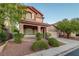 Attractive exterior elevation of a home with well-maintained landscaping and two-car garage at 1011 Pecos River Ave, Henderson, NV 89002